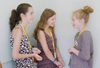 Študenti detského programu sa rozprávajú na základnej škole